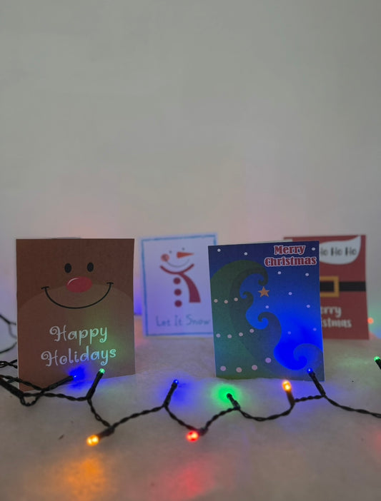 Collection of Christmas cards with decorative lights on a white surface