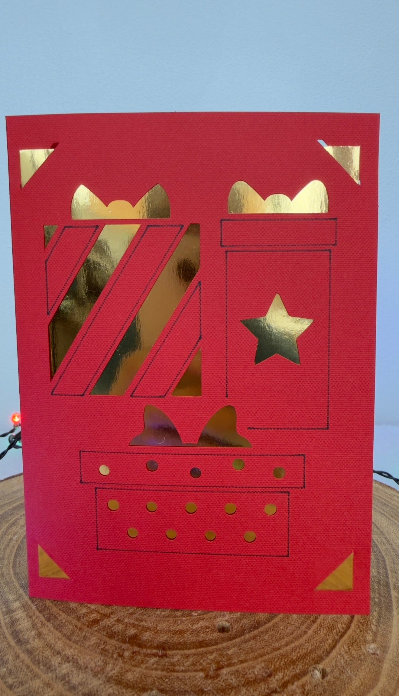 Red card with gold cut-out numbers '74' and star on a wooden surface.