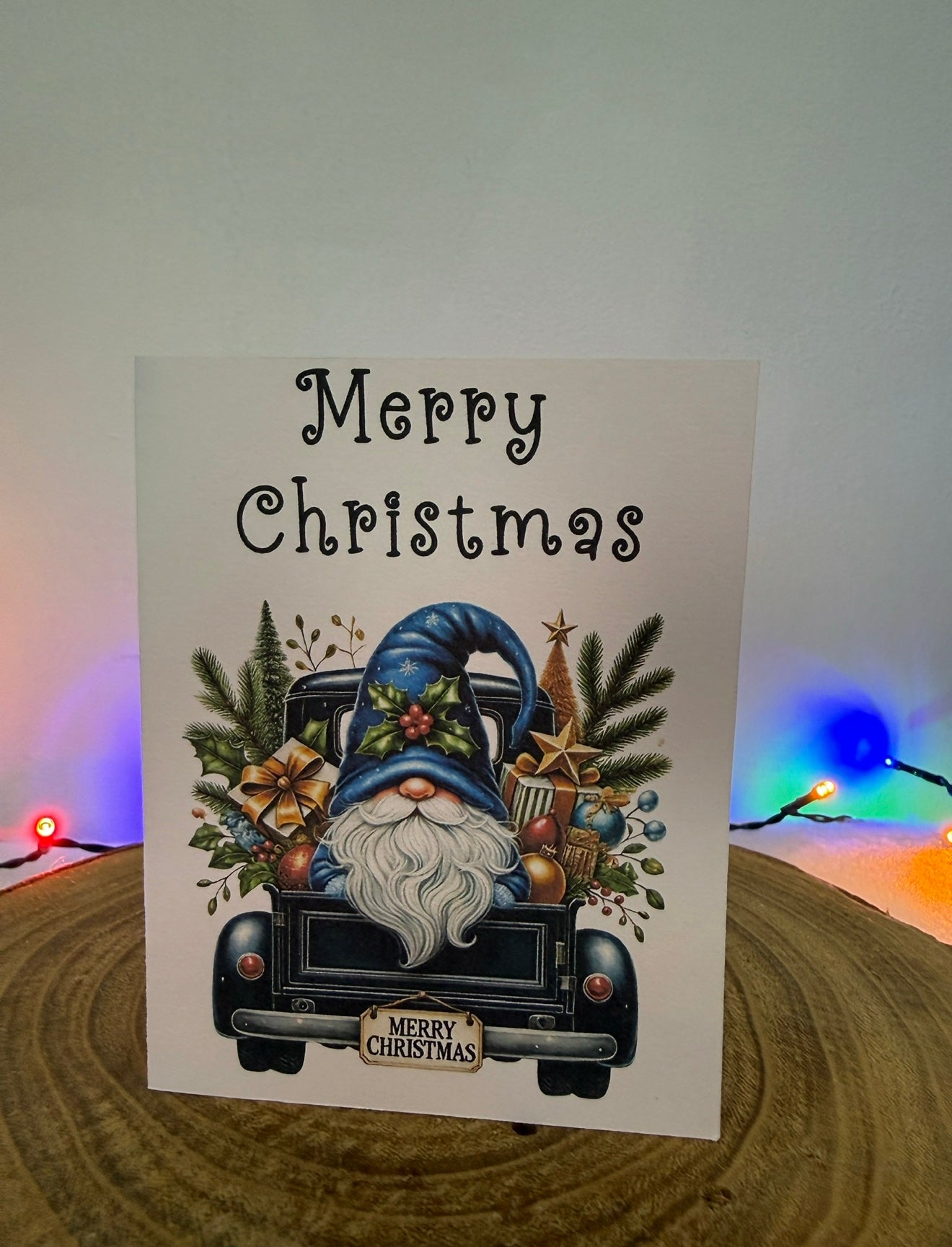 Christmas card with a gnome and truck design on a white background