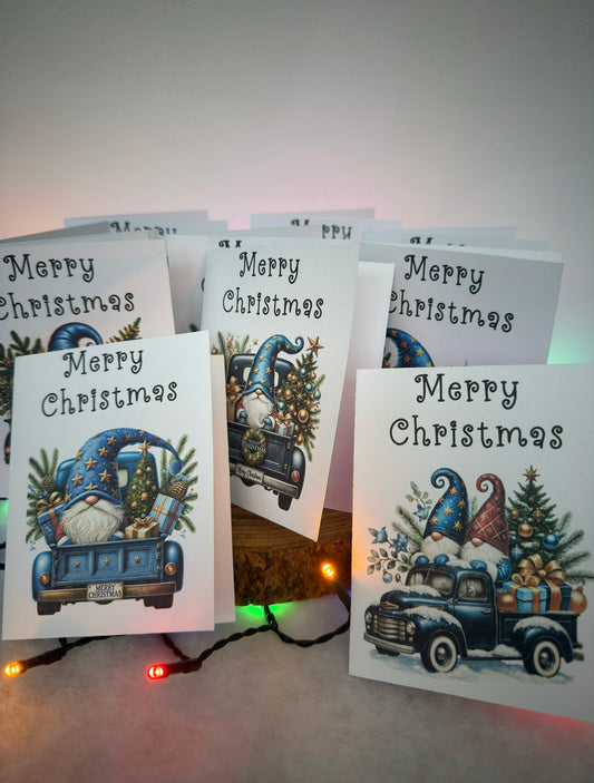 Set of Christmas cards with blue truck and gnome designs on a white background.